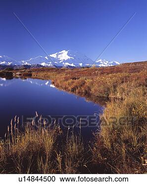 Stock Photography - pond by snow capped 
mountains. fotosearch 
- search stock 
photos, pictures, 
images, and photo 
clipart
