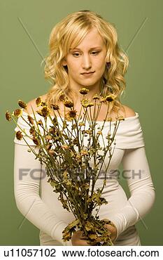 Stock Photo - lady looking at 
wilted flowers. 
fotosearch - search 
stock photos, 
pictures, images, 
and photo clipart