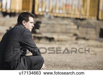 Stock Photo - man in a pinstriped 
suit bending down. 
fotosearch - search 
stock photos, 
pictures, images, 
and photo clipart