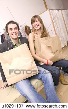 Picture - caucasian couple 
happy with their 
purchases at a 
trendy boutique. 
fotosearch - search 
stock photos, 
pictures, images, 
and photo clipart