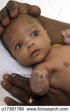Stock Image - hands holding 
and comforting 
an african american 
baby. fotosearch 
- search stock 
photos, pictures, 
images, and photo 
clipart