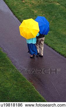 Stock Photo - couple with umbrellas. 
fotosearch - search 
stock photos, 
pictures, images, 
and photo clipart