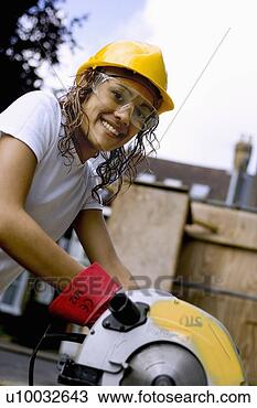 Stock Photo - young woman using 
a circular saw 
on a construction 
site with hard 
hat. fotosearch 
- search stock 
photos, pictures, 
images, and photo 
clipart