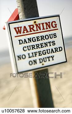 Stock Photo - warning sign on 
post at the beach 
with ocean in 
background. fotosearch 
- search stock 
photos, pictures, 
images, and photo 
clipart