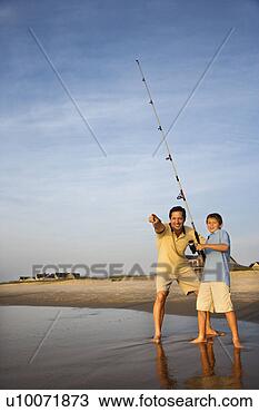 Stock Photo - caucasian mid-adult 
man shore fishing 
on beach with 
pre-teen boy and. 
fotosearch - search 
stock photos, 
pictures, images, 
and photo clipart