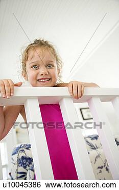 Stock Photo - caucasian female 
child peeking 
over railing. 
fotosearch - search 
stock photos, 
pictures, images, 
and photo clipart