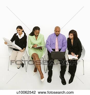 Stock Photo - multi-ethnic business 
group of men and 
women sitting 
looking at. fotosearch 
- search stock 
photos, pictures, 
images, and photo 
clipart