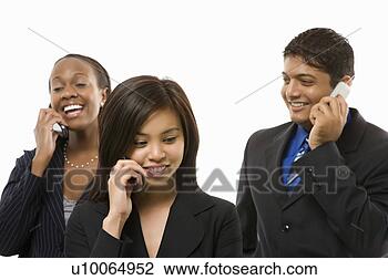 Stock Photo - multi-ethnic businesswomen 
and businessman 
standing talking 
on cell. fotosearch 
- search stock 
photos, pictures, 
images, and photo 
clipart