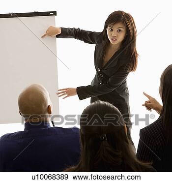 Stock Photograph - vietnamese mid-adult  woman standing  in front of business  group. fotosearch  - search stock  photos, pictures,  images, and photo  clipart