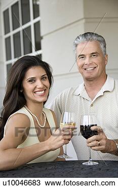 Stock Photo - prime adult hispanic 
female and caucasian 
prime adult male 
toasting. fotosearch 
- search stock 
photos, pictures, 
images, and photo 
clipart