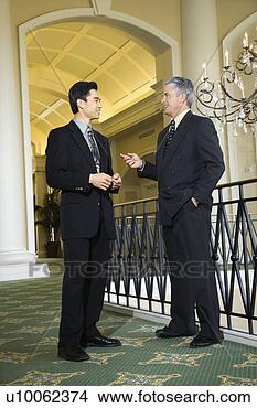 Stock Photo - caucasian adult 
male businessman 
and asian adult 
male businessman 
in. fotosearch 
- search stock 
photos, pictures, 
images, and photo 
clipart