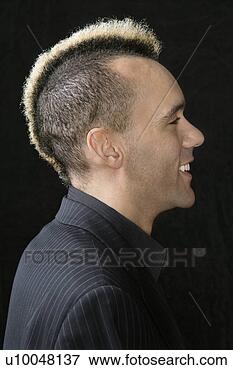 Picture - portrait of caucasian 
man in suit with 
mohawk against 
black background. 
fotosearch - search 
stock photos, 
pictures, images, 
and photo clipart