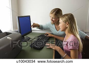 Stock Photo - caucasian pre-teen 
girl and caucasian 
prime mid-adult 
woman working. 
fotosearch - search 
stock photos, 
pictures, images, 
and photo clipart