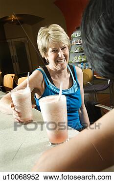 Stock Photo - mature caucasian 
adult females 
sitting at table 
in health club. 
fotosearch - search 
stock photos, 
pictures, images, 
and photo clipart