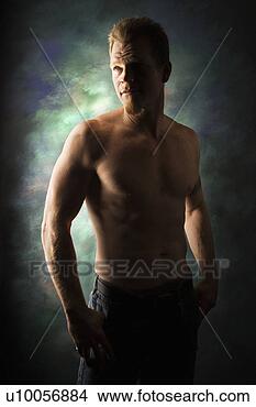Stock Photo - dramatically lit 
portrait of shirtless 
young adult caucasian 
man on. fotosearch 
- search stock 
photos, pictures, 
images, and photo 
clipart