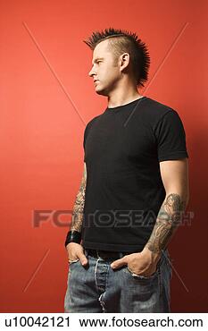 Stock Photography - caucasian man 
with mohawk and 
tattoos standing 
with hands in 
pockets. fotosearch 
- search stock 
photos, pictures, 
images, and photo 
clipart