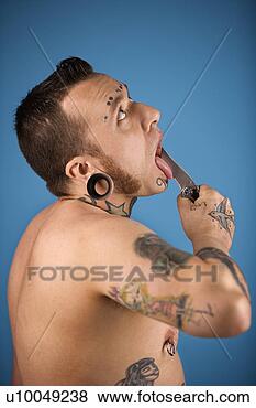 Stock Photo - caucasian mid-adult 
man with tattoos 
and piercing holding 
knife to. fotosearch 
- search stock 
photos, pictures, 
images, and photo 
clipart