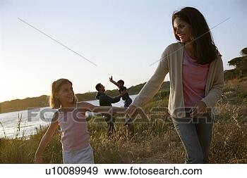 Stock Photograph - family in park 
playing by lakeside. 
fotosearch - search 
stock photos, 
pictures, images, 
and photo clipart