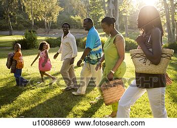 Stock Photograph - three generations 
of family walking 
in park. fotosearch 
- search stock 
photos, pictures, 
images, and photo 
clipart