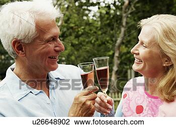 Stock Photo - close-up of a 
mature couple 
toasting champagne 
flutes. fotosearch 
- search stock 
photos, pictures, 
images, and photo 
clipart
