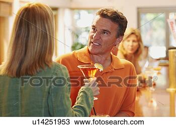 Stock Photo - close-up of a 
mature man talking 
to a woman in 
a bar. fotosearch 
- search stock 
photos, pictures, 
images, and photo 
clipart