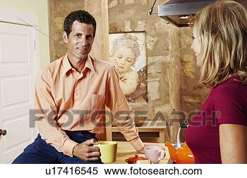 Stock Image - portrait of a 
mature man holding 
a cup with a mature 
woman standing. 
fotosearch - search 
stock photos, 
pictures, images, 
and photo clipart