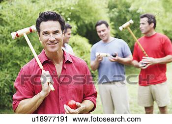 Stock Photography - portrait of a 
mature man holding 
a croquet mallet 
and a ball with 
his. fotosearch 
- search stock 
photos, pictures, 
images, and photo 
clipart