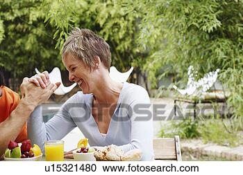 Stock Photography - close-up of a 
mature woman arm 
wrestling with 
a mature man. 
fotosearch - search 
stock photos, 
pictures, images, 
and photo clipart