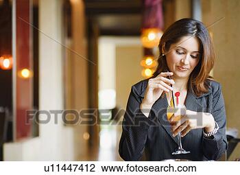 Stock Photo - close-up of a 
young woman holding 
a glass of pinacolada. 
fotosearch - search 
stock photos, 
pictures, images, 
and photo clipart
