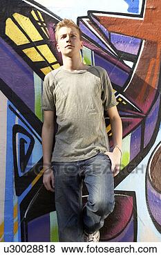 Stock Photo - a teenager standing 
against a mural. 
fotosearch - search 
stock photos, 
pictures, images, 
and photo clipart