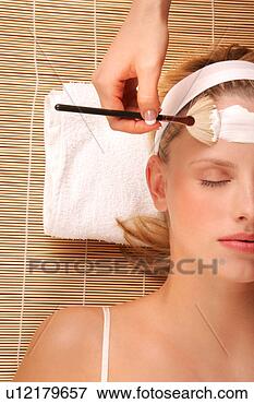 Picture - a young woman 
receiving a facial. 
fotosearch - search 
stock photos, 
pictures, images, 
and photo clipart