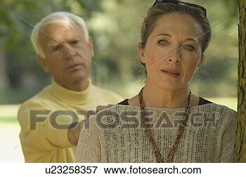 Picture - a woman leaning 
on a tree, man 
consoling her. 
fotosearch - search 
stock photos, 
pictures, images, 
and photo clipart