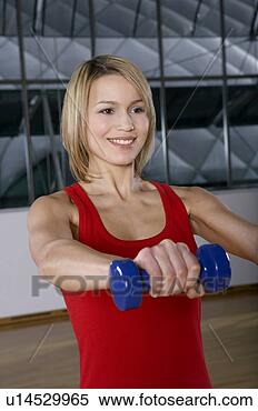 Stock Image - woman doing weight 
training in gym. 
fotosearch - search 
stock photos, 
pictures, images, 
and photo clipart