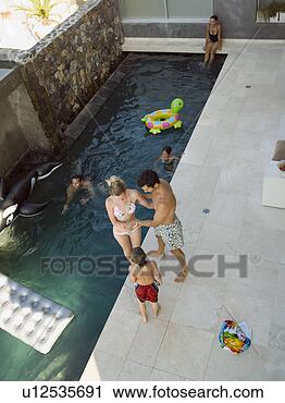 Stock Photography - parents and children 
playing by the 
swimming pool. 
fotosearch - search 
stock photos, 
pictures, images, 
and photo clipart