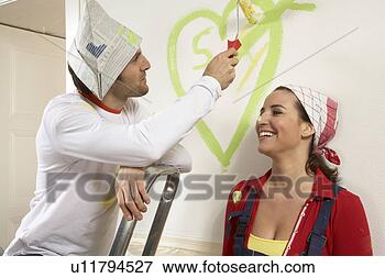 Picture - close-up of a 
young man painting 
a heart on a wall 
with a young woman. 
fotosearch - search 
stock photos, 
pictures, images, 
and photo clipart