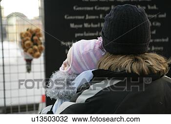 Stock Photo - woman with baby 
(12-15) looking 
at notice board. 
fotosearch - search 
stock photos, 
pictures, images, 
and photo clipart