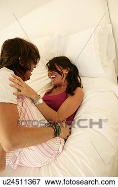 Picture - view of a couple 
playing around 
on a bed. fotosearch 
- search stock 
photos, pictures, 
images, and photo 
clipart