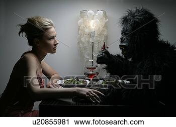 Stock Photography - a woman is dining 
with a man in 
a gorilla costume. 
fotosearch - search 
stock photos, 
pictures, images, 
and photo clipart