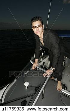 Stock Photo - view of a young 
man on a yacht. 
fotosearch - search 
stock photos, 
pictures, images, 
and photo clipart