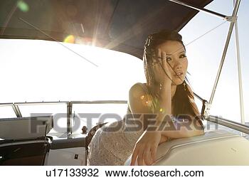 Stock Photo - view of a young 
woman on a yacht. 
fotosearch - search 
stock photos, 
pictures, images, 
and photo clipart