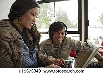 Stock Photograph - couple working 
on laptop. fotosearch 
- search stock 
photos, pictures, 
images, and photo 
clipart