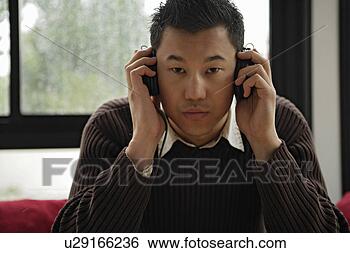 Stock Photo - one young man 
listening music, 
portrait. fotosearch 
- search stock 
photos, pictures, 
images, and photo 
clipart