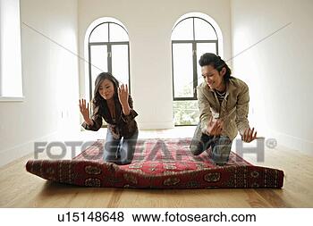 Stock Photo - two people kneeling 
on carpet, front 
view. fotosearch 
- search stock 
photos, pictures, 
images, and photo 
clipart
