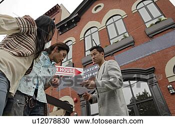 Stock Photography - two young women 
talking to a man, 
side view. fotosearch 
- search stock 
photos, pictures, 
images, and photo 
clipart