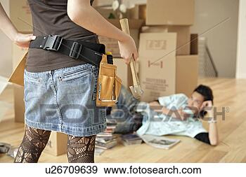 Stock Photograph - woman holding 
hammer, rear view. 
fotosearch - search 
stock photos, 
pictures, images, 
and photo clipart