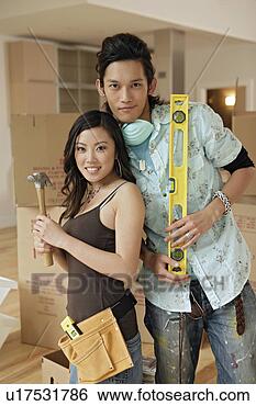 Stock Photo - young couple with 
hammer and spirit 
level, portrait. 
fotosearch - search 
stock photos, 
pictures, images, 
and photo clipart