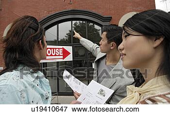 Picture - young couple with 
house agent. fotosearch 
- search stock 
photos, pictures, 
images, and photo 
clipart