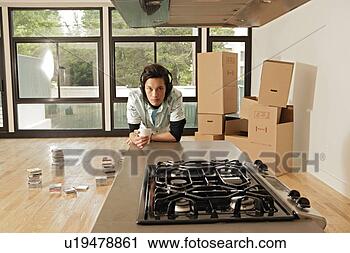 Stock Photography - a young man leaning 
against table. 
fotosearch - search 
stock photos, 
pictures, images, 
and photo clipart