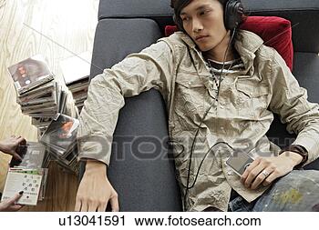 Stock Photography - a young man listening 
music. fotosearch 
- search stock 
photos, pictures, 
images, and photo 
clipart
