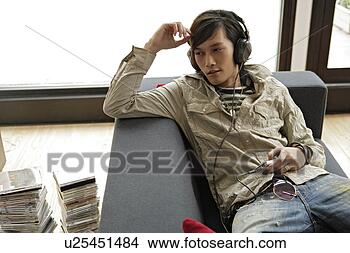 Stock Photo - young man listening 
to music. fotosearch 
- search stock 
photos, pictures, 
images, and photo 
clipart